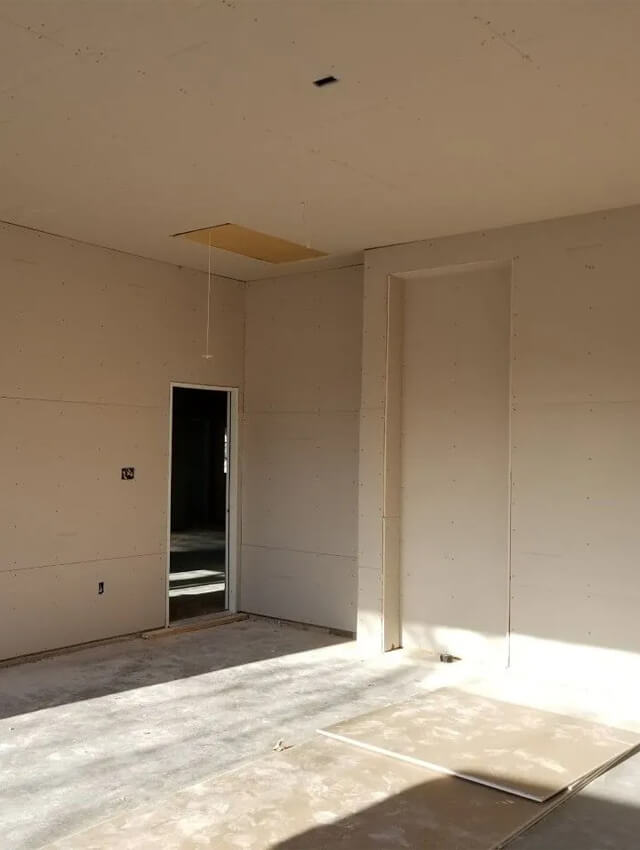 services-drywall-installation New drywall installation in an unfinished room