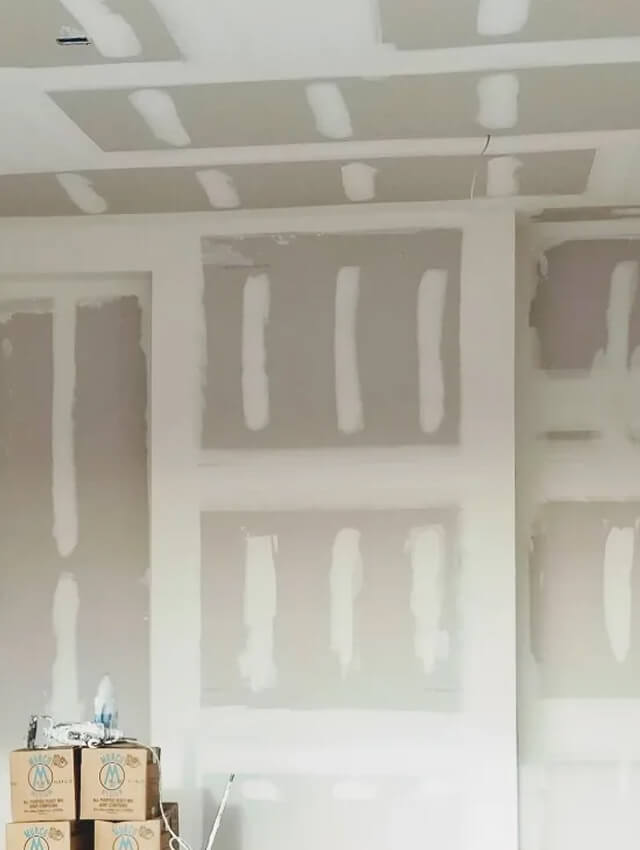 Drywall installation with taped and mudded seams in a new interior spac